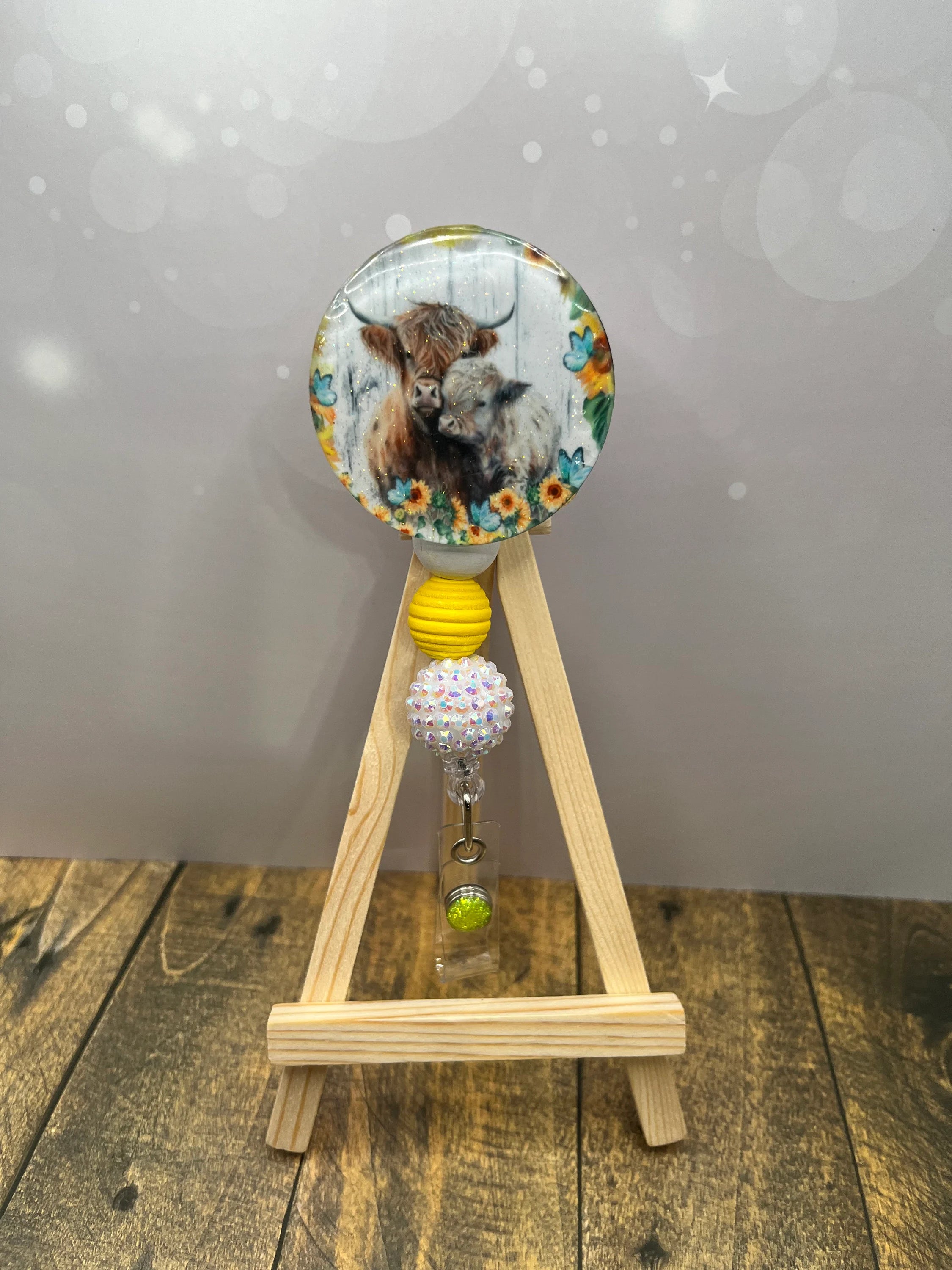 Highland Cow badge pulls. Brighten your shift, one cow at a time. Multiple Images available. Add beads or shimmer glitter options.