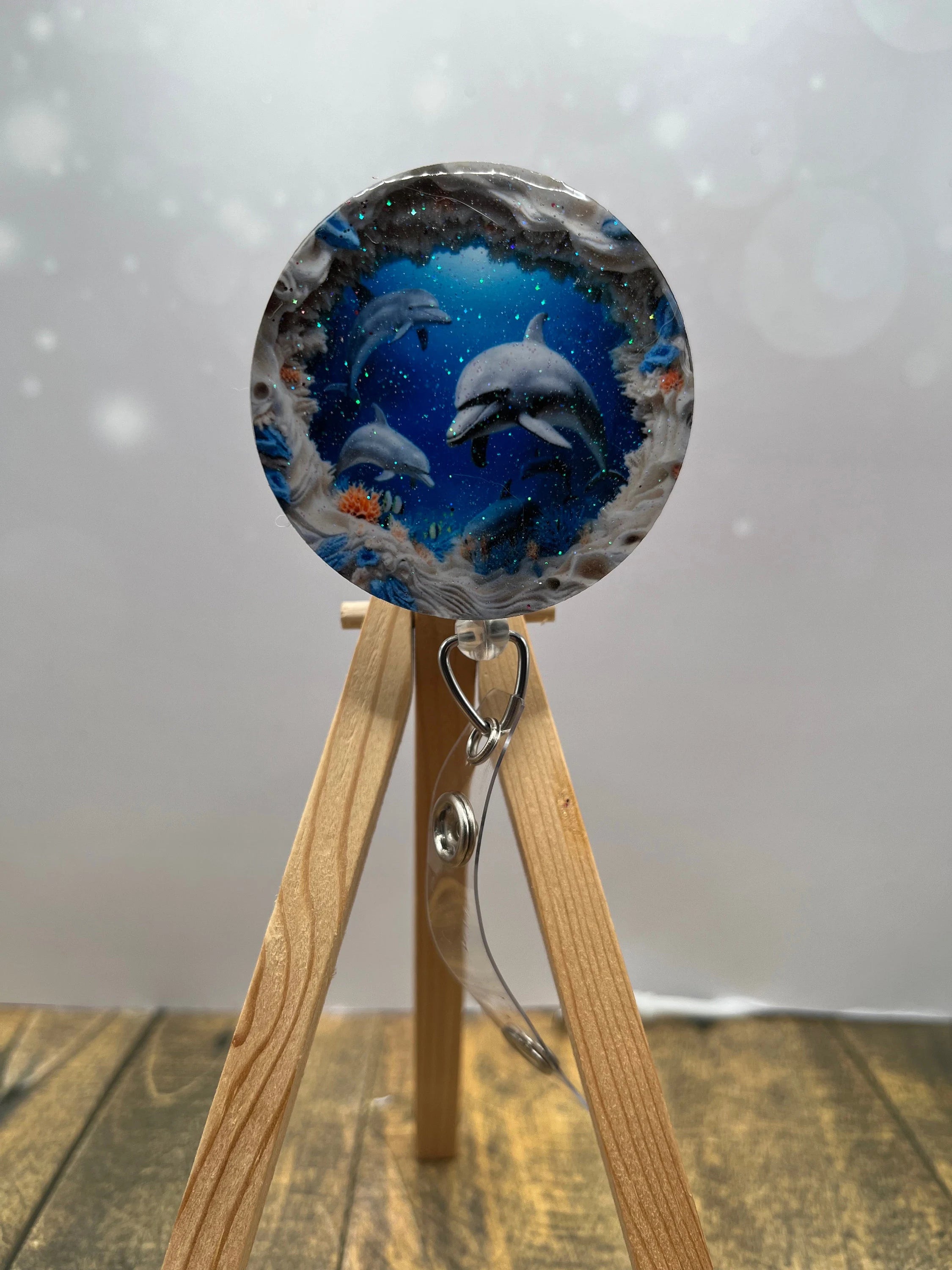 Dolphin badge pulls. Cute, coastal, and ready for every shift. Multiple Images available. Add beads or shimmer glitter options.